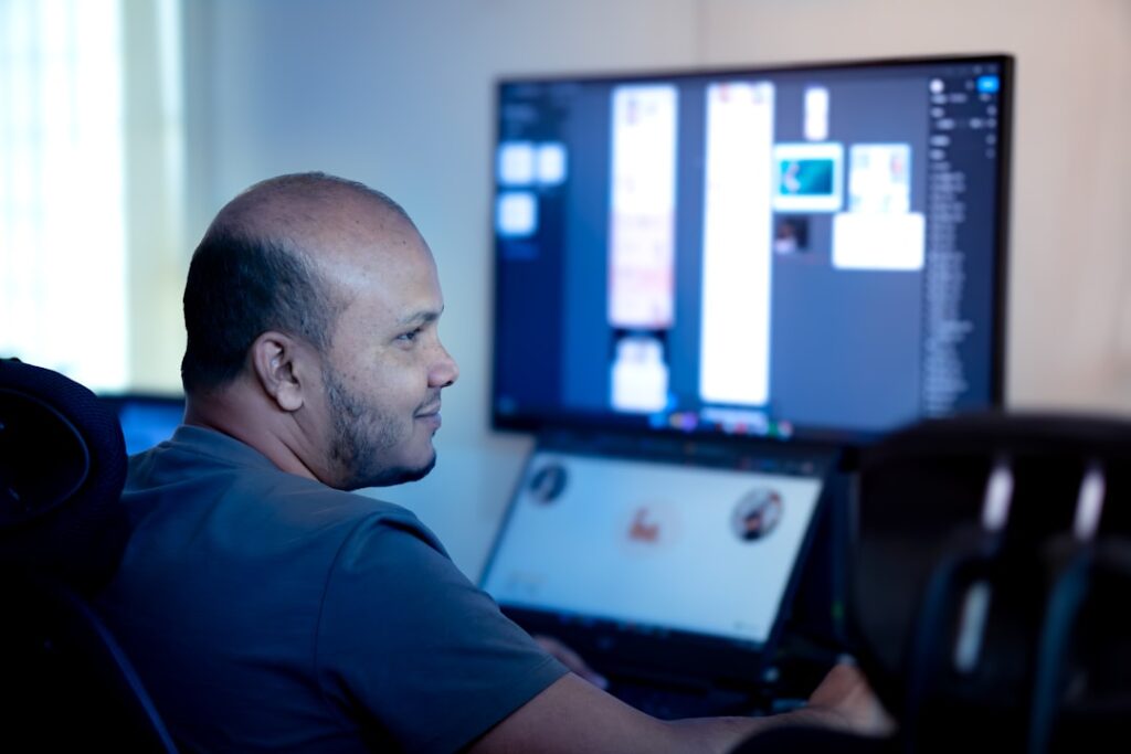 person looking at a computer screen in a well-lit office room